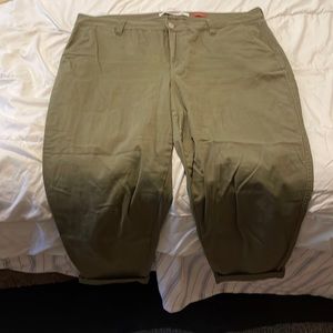 Army green ankle pants with cuffs folded up.